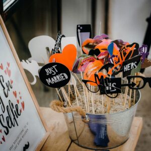 Creative wedding photobooth props with fun designs like glasses and moustaches.